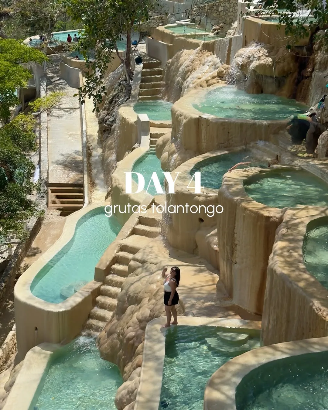 Thermal pools on a bright day with visitors enjoying the water